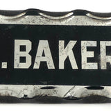 P.A. Baker, Silver Foil and Reverse Painted Glass Nameplate with Scalloped Edge