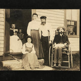 Curious Antique Photograph with Man in Wheelchair, Man on Crutches and Sickly Child