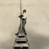 Clinging to the Top, Old Snapshot Photo of Tower Climber