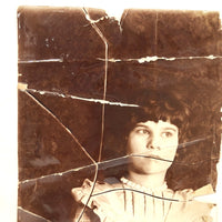 Striking Torn Up and Taped Back Together Old Photo of Girl Looking Sideward