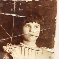 Striking Torn Up and Taped Back Together Old Photo of Girl Looking Sideward