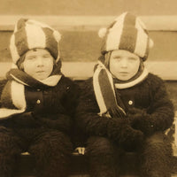 Twins in Striped Hats and Scarves and Wooly Snowsuits, in Wagon, Old RPPC