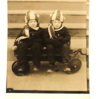 Twins in Striped Hats and Scarves and Wooly Snowsuits, in Wagon, Old RPPC