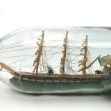 Wonderful Old Folk Art Ship in a Bottle with Little Houses, Flags, and Tower Perched on Push Up Bottom