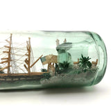 Wonderful Old Folk Art Ship in a Bottle with Little Houses, Flags, and Tower Perched on Push Up Bottom