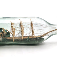 Wonderful Old Folk Art Ship in a Bottle with Little Houses, Flags, and Tower Perched on Push Up Bottom