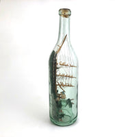 Wonderful Old Folk Art Ship in a Bottle with Little Houses, Flags, and Tower Perched on Push Up Bottom