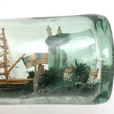 Wonderful Old Folk Art Ship in a Bottle with Little Houses, Flags, and Tower Perched on Push Up Bottom