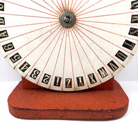 Spinning Orange and White Carnival Wheel of Chance, A-Z Plus 1-6